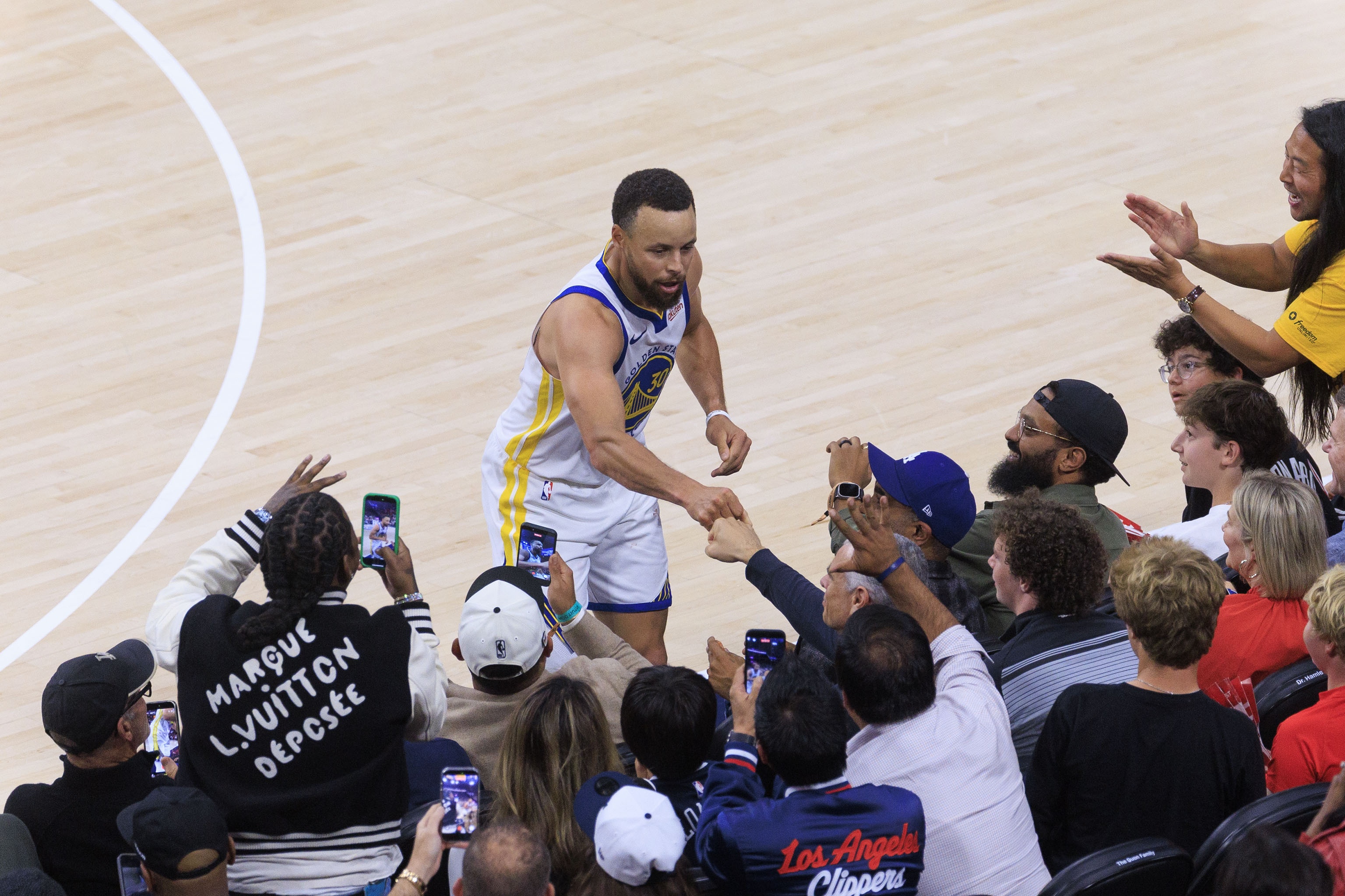 库里三分倒地遭快船球迷推搡 双方赛后碰拳致意